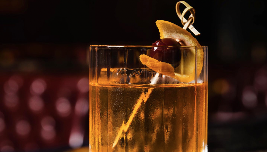 Glass of Bourbon in a dark cocktail lounge